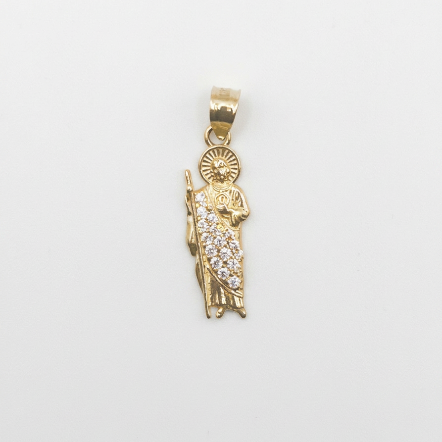 A gold pendant featuring a detailed figure of the Virgin Mary adorned with small clear pavé stones, set against a plain white background.